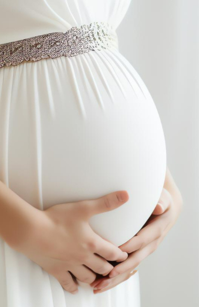 Expectant mother cradling her belly, symbolizing the miracle of life nurtured through Wellness at Umra’s fertility treatments.